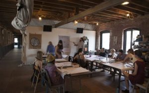 Former-resident woodworker Thomas Beale's studio was visible and open to other residents and passersby, encouraging interactive dialogue. (source: Wikipedia)